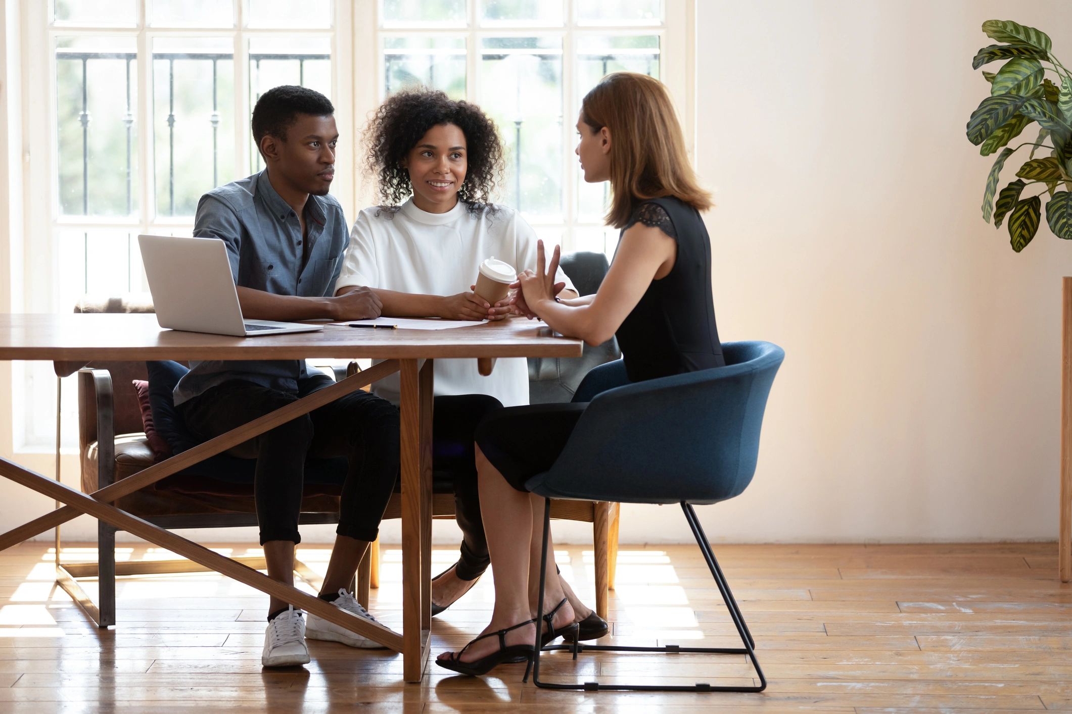 Real estate consultation with clients at a desk
